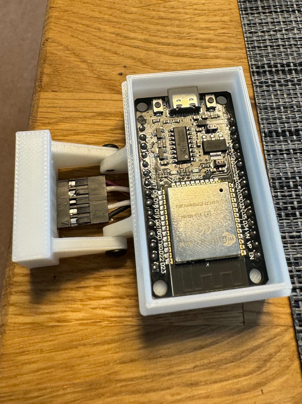 ESP32 microcontroller mounted in a 3D printed DIN rail enclosure